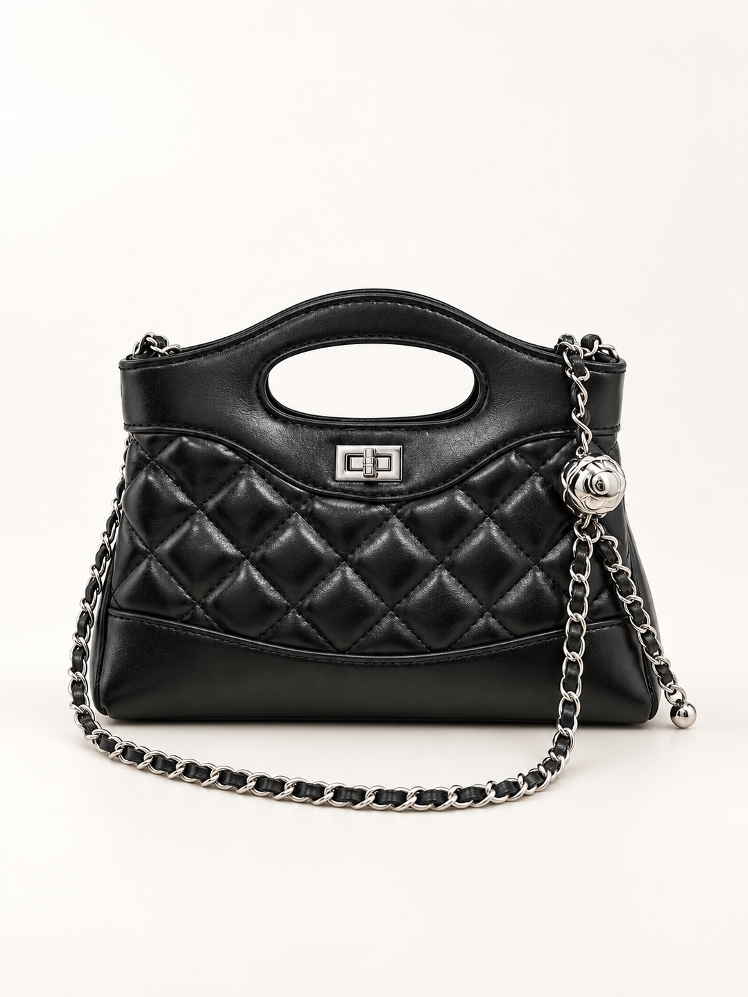 Maven Quilted Top Handle Bag in Black — studio view showing material and hardware.
