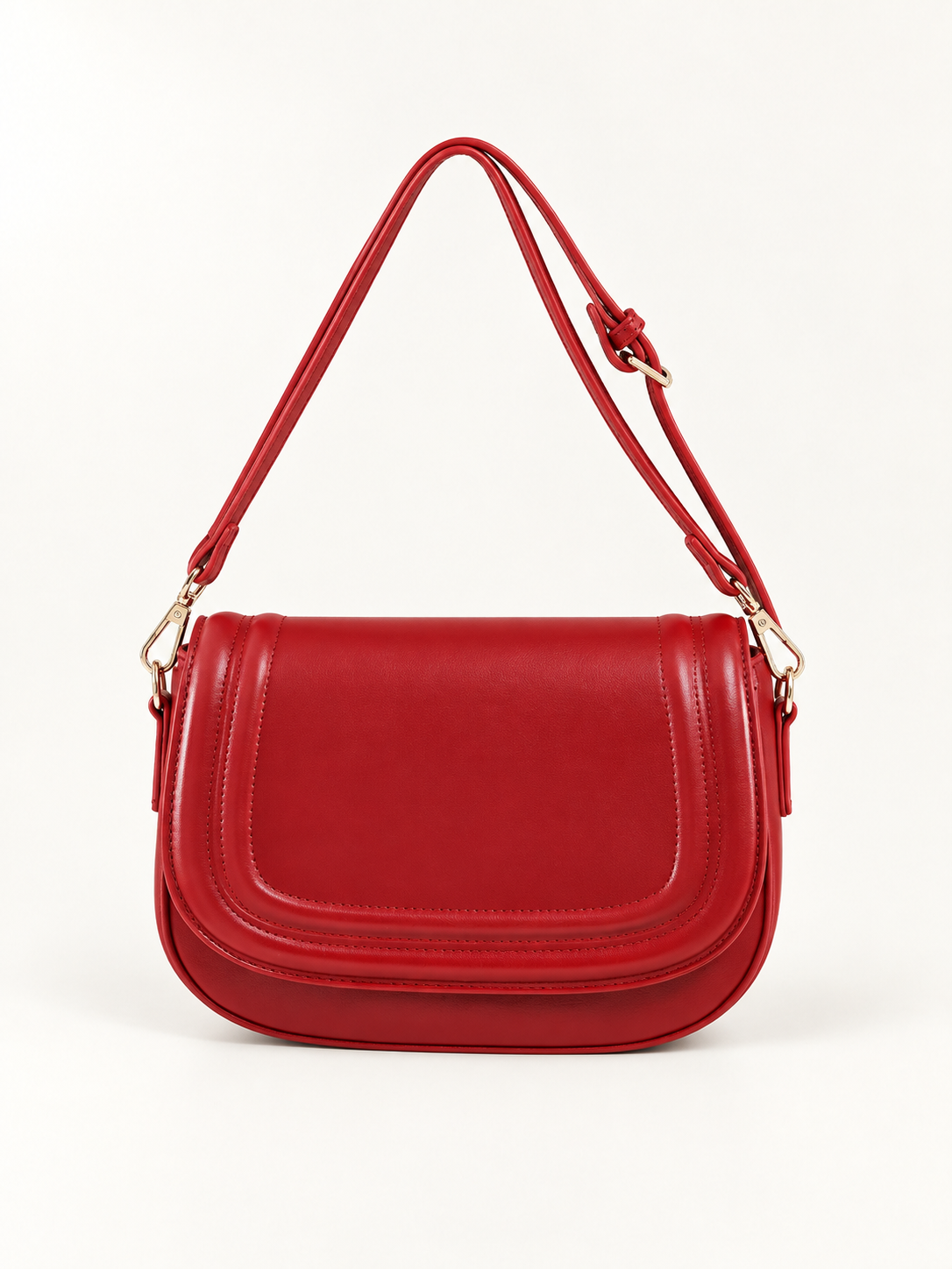 Maven Saddle Crossbody Bag in Red — studio view showing material and hardware.