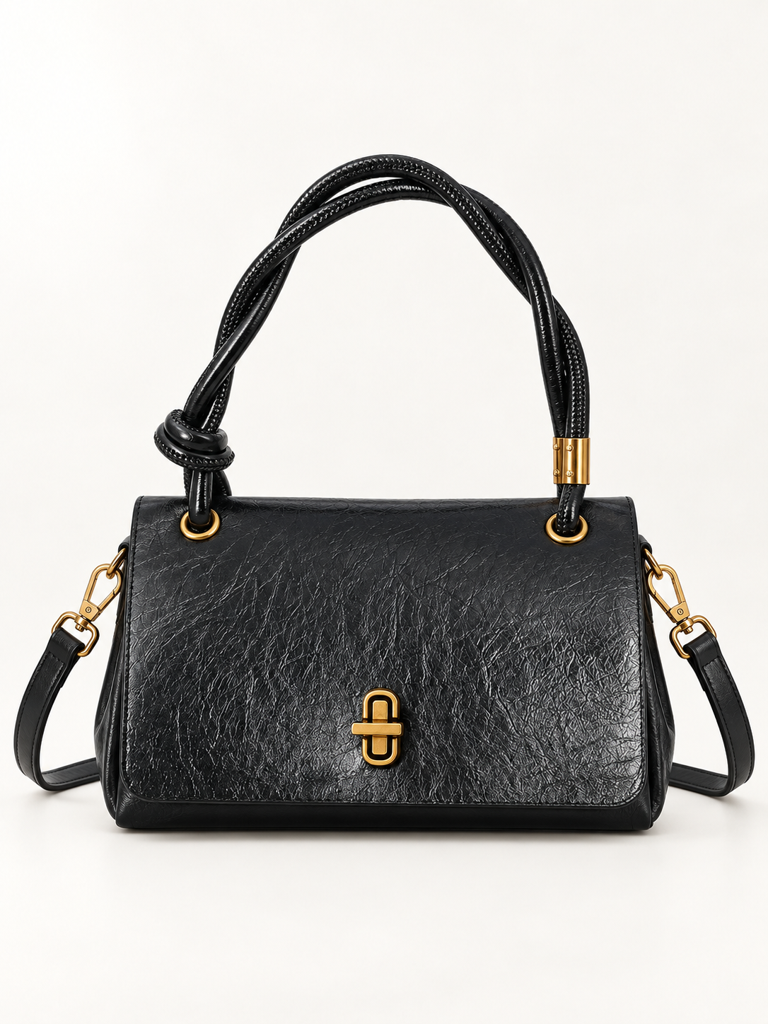 Maven Twisted Handle Crossbody in Black — studio view showing material and hardware.