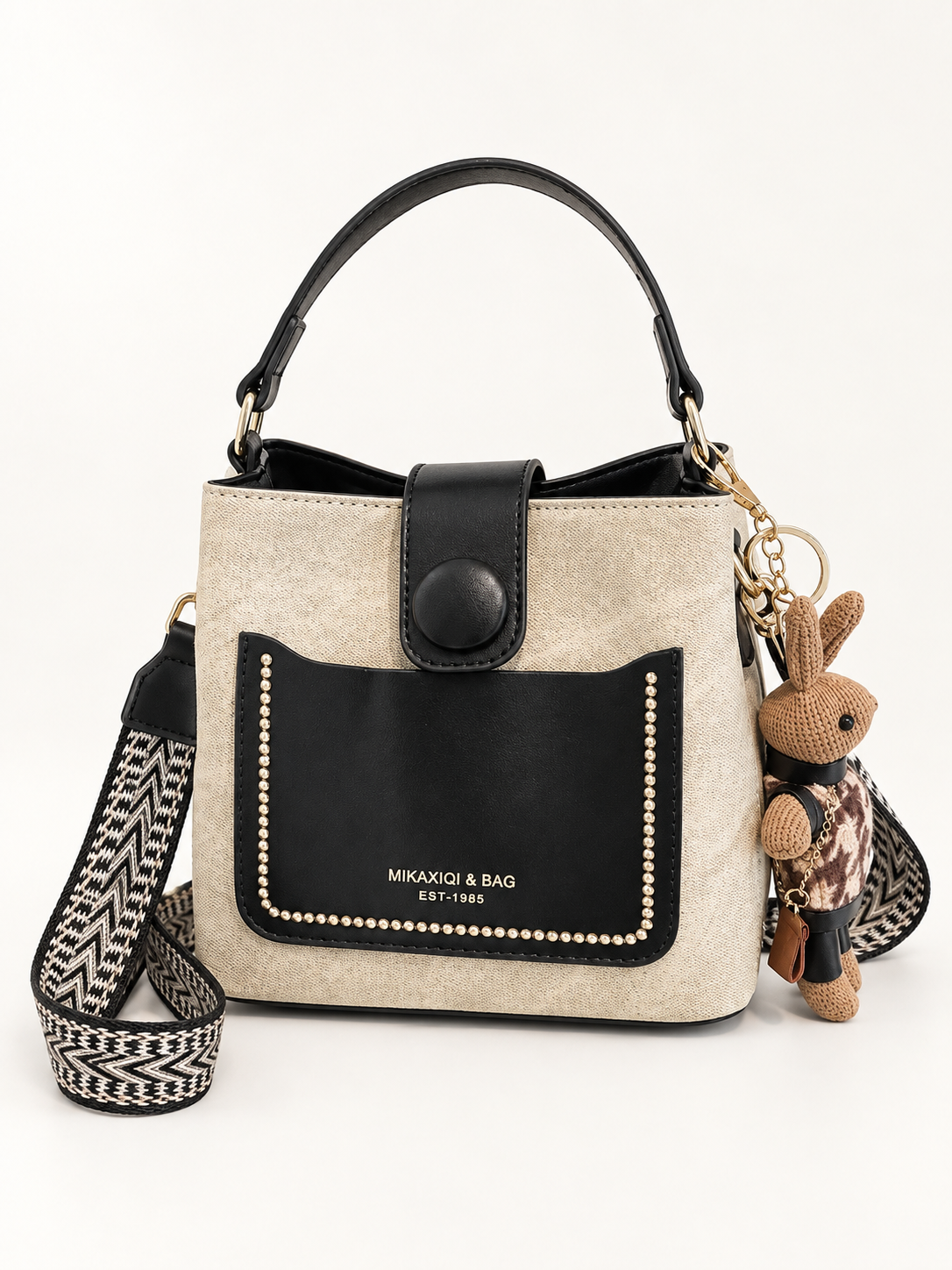 Maven Two-Tone Bucket Bag in Black — studio view showing material and hardware.